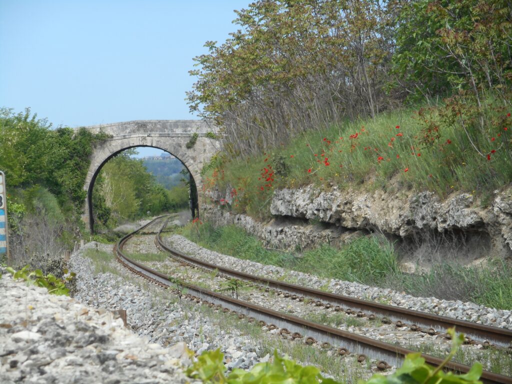 ancient bridge above railway by Montalceto path in Crete Senesi region near Asciano, Italy