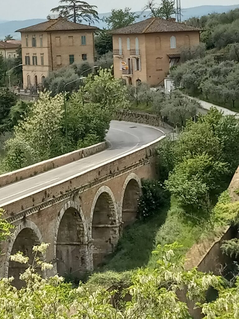 beautiful bridge over river in Siena, Italy