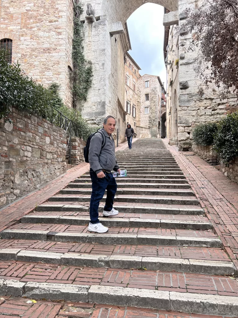 path passing under Porta Trasimena in Perugia, Italy